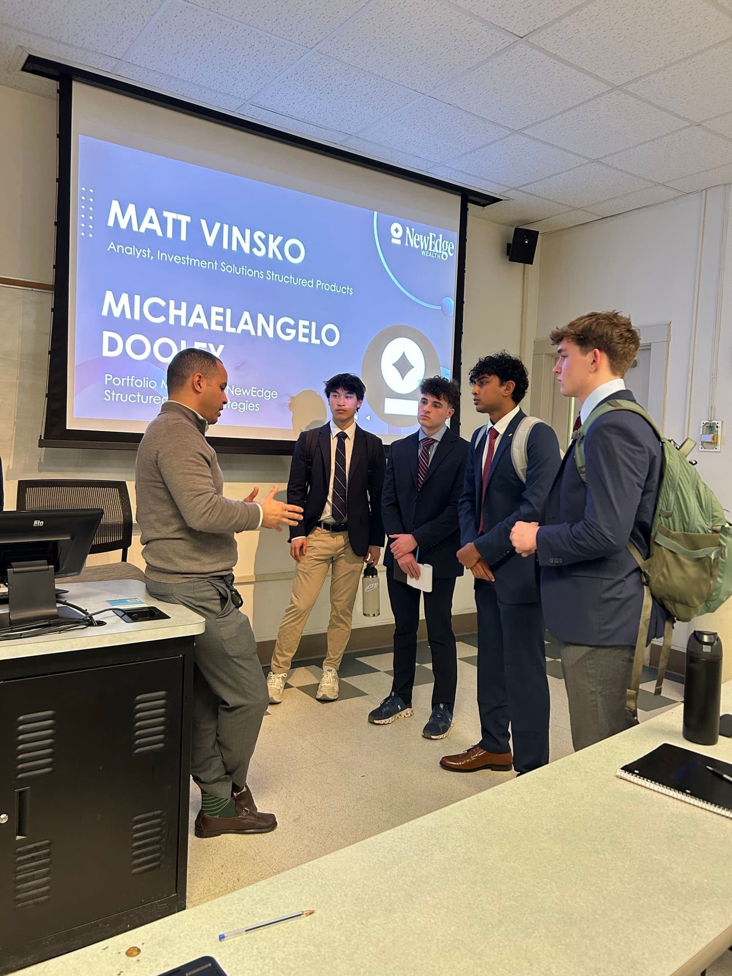 Eta Theta members speaking with a guest speaker after a professional development event